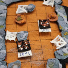 Cavern walls surround rocks, stalagmites and cobwebs. Swarms of bats fly through the middle with tags indicating their altitude